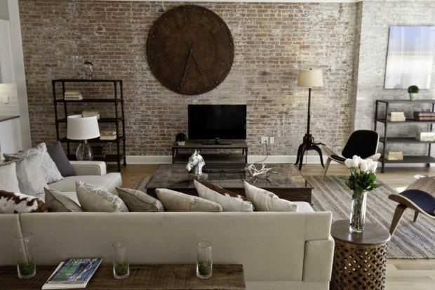 modern-industrial-bedroom-interior-design-brick-wall-scheme-with-wooden-big-circle-clock-beige-foamy-bed-sofa-set-l-shape-with-decorati